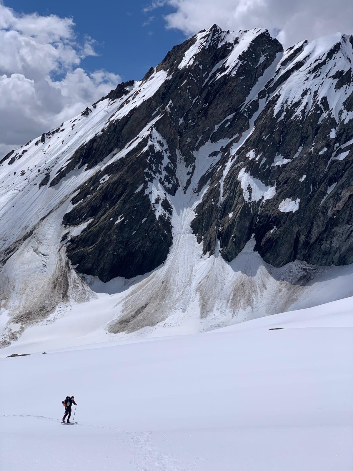 A climber alone under a mountain face, from the Train to Mountain book